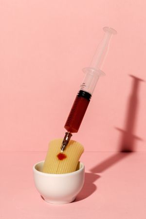 Stuffed pasta with red sauce in syringe