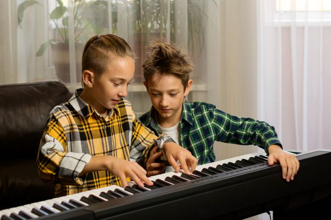 Brothers Practicing Piano Together