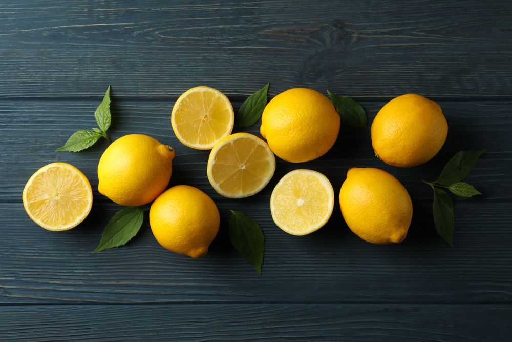 Fresh lemons on wooden background, top view. Ripe fruit