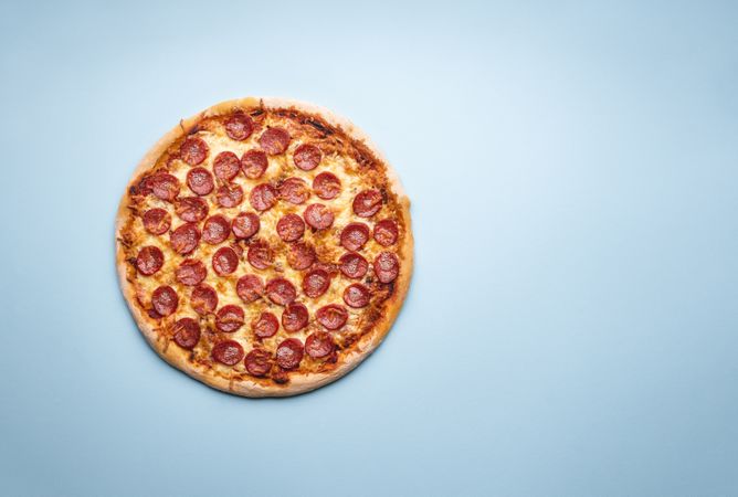 Whole pizza on a blue background