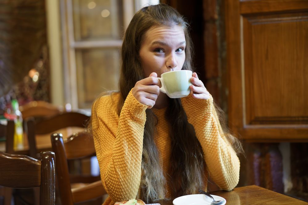 Cozy Caf Moment Young Woman Enjoying Tea