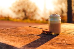 Cinnamon near coffee on table