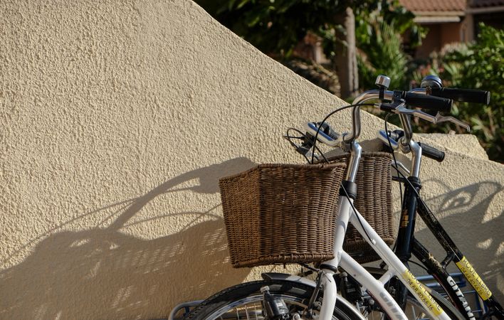 Parked bicycles on a wall with thatched baskets