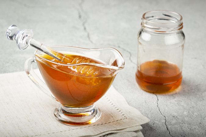 Honey in glass bowl on the table.