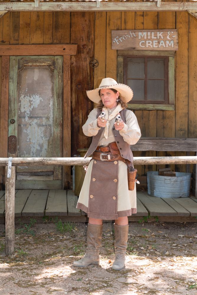 "Pistol Packin' Paula" Saletnik pointing guns at Enchanted Springs Ranch, Boerne, Texas