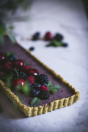 Fresh blueberry pistachio cake with whole berries on top