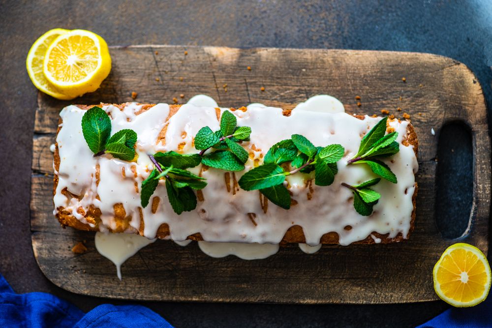 Top of homemade lemon drizzle cake with fresh mint garnish