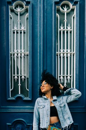 Stylish Black female by blue door