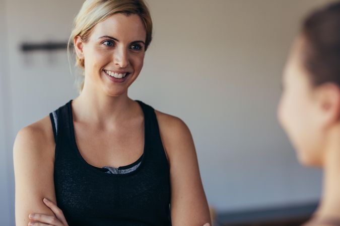 Smiling woman in fitness wear at a pilates training gym
