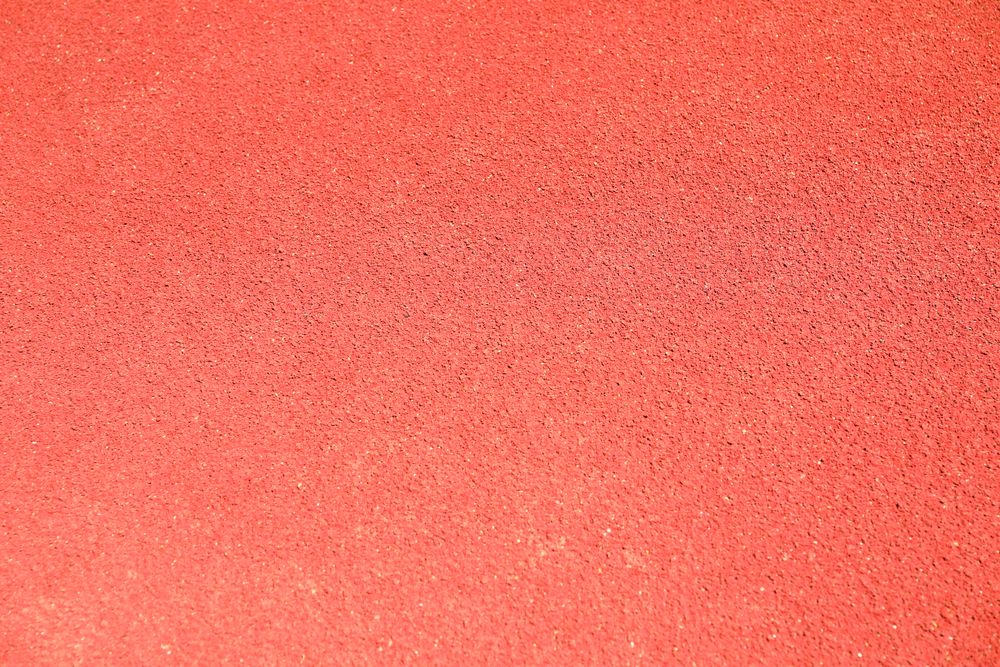 Red rubber running track background, top view