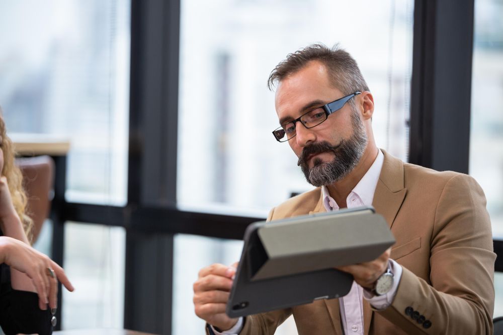 Businessman presenting project on digital tablet