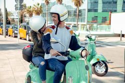 Couple sitting on scooter and talking