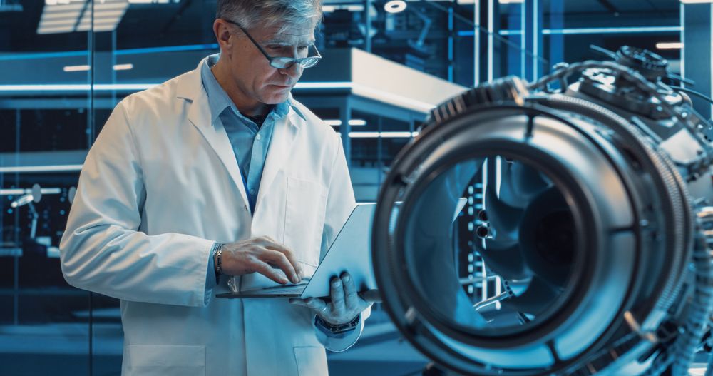 Man Standing with Laptop Computer in Scientific Technology Lab. Scientist