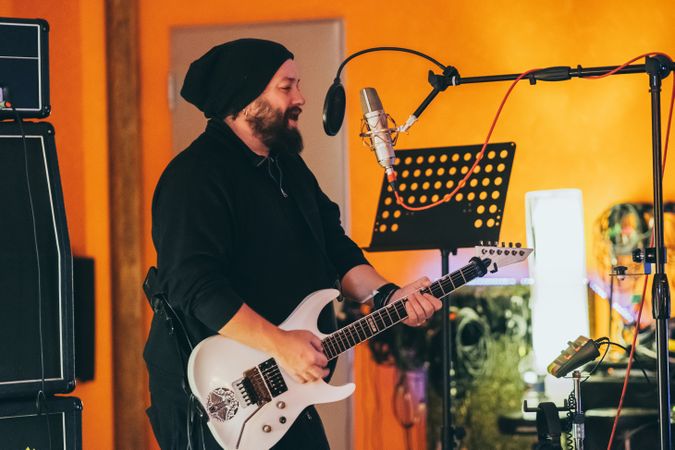 Musician playing guitar and singing