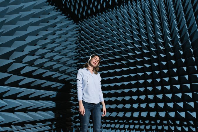 Woman in sound room listening to music