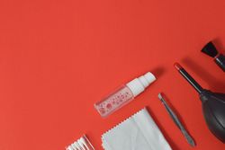 Top view of lens cleaning kit on red table