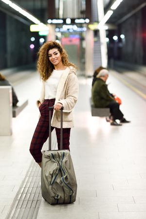Arab woman in casual clothes with bag in underground station