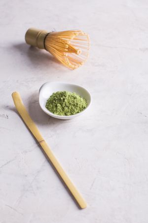 Green matcha tea powder and bamboo whisk