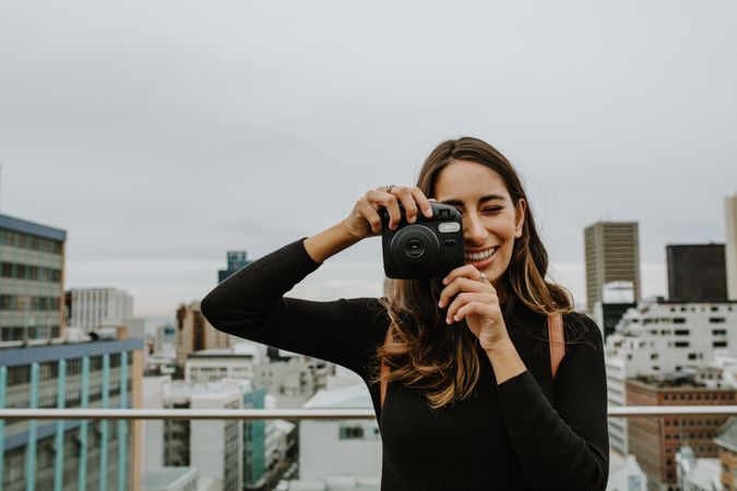 Woman taking pictures with an instant camera