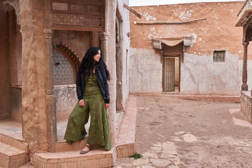 Woman on street between ancient buildings