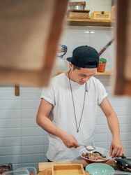 Asian cook working in kitchen