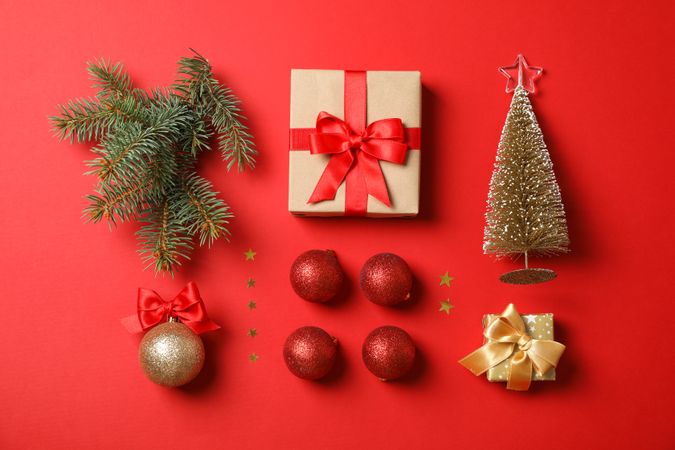 Flat lay with Christmas accessories on red background, space for text