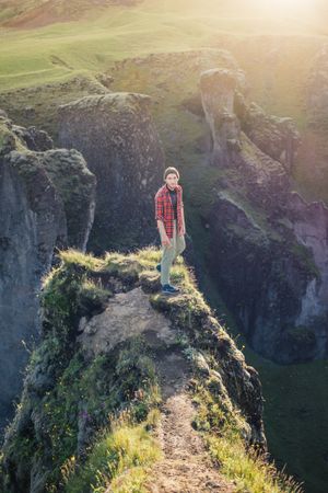 Man standing on edge of cliff