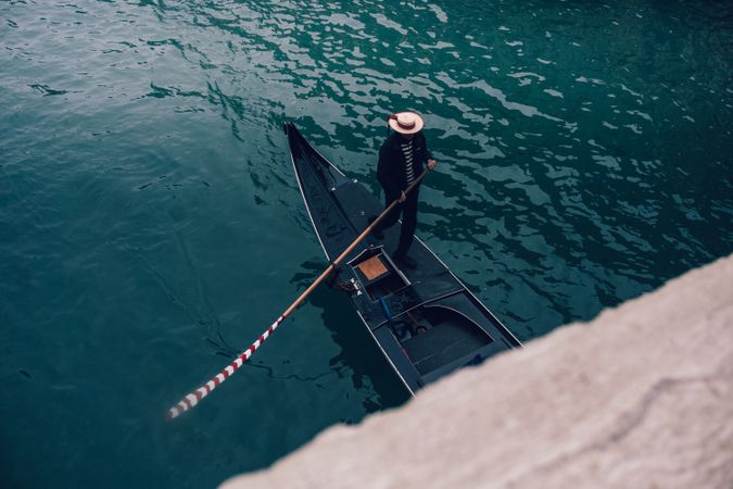 Man riding gondola on body of water