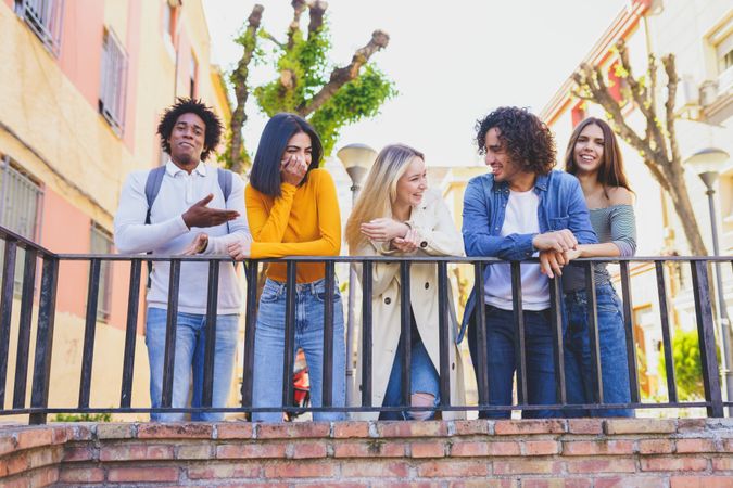 Male and female friends joking around outside