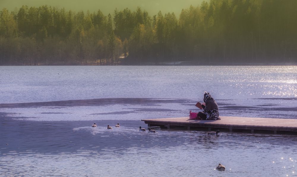 Young woman relaxing on Bled lakes pier