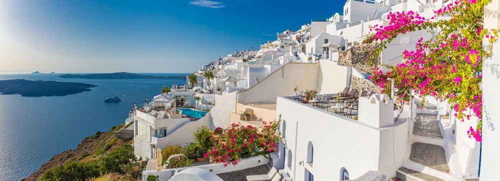 Panoramic shot of cliff side Santorini and the Aegean Sea