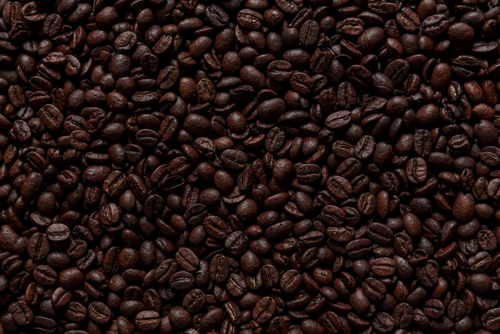Layer of coffee beans flat lay