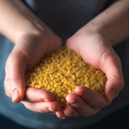 ptitim pasta or couscous in female hands