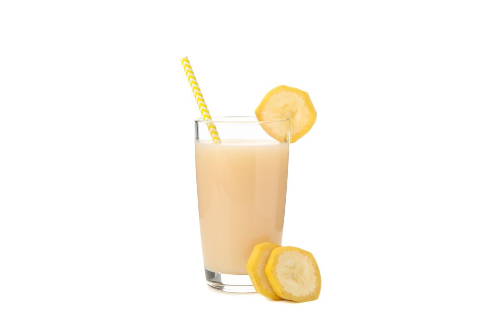 Banana juice isolated on studio background. Fresh fruit