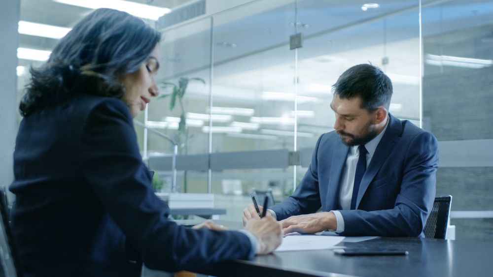 Businesswoman and Businessman Have Conversation. Sign Documents, Draw up a Contract, Seal the Deal