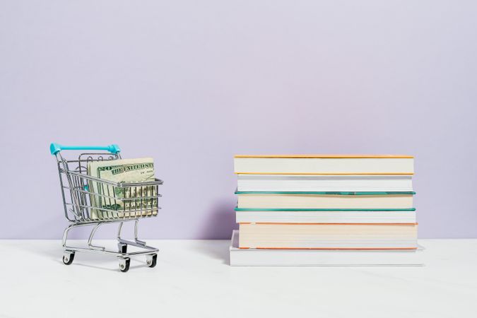 Stack of books beside shopping cart