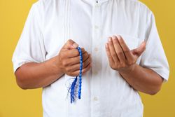 Hands of Muslim Old Man with Prayer Beads