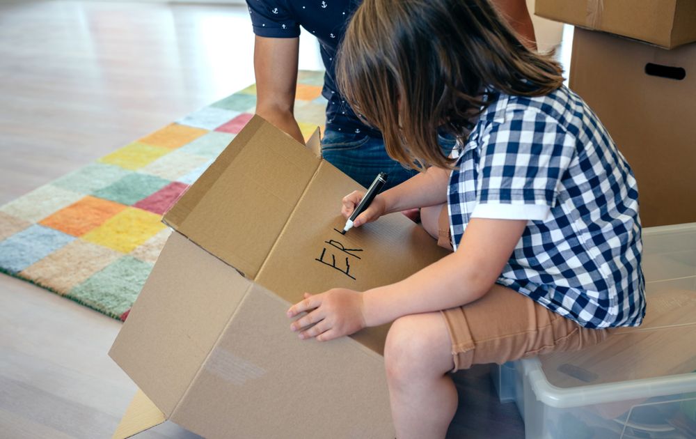 Boy writing in a moving box