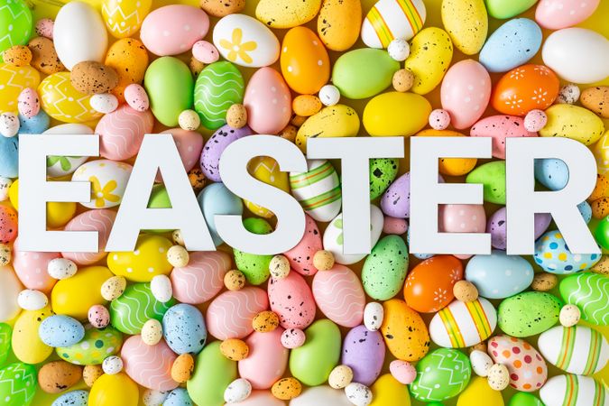Texture of pastel eggs with “EASTER” text