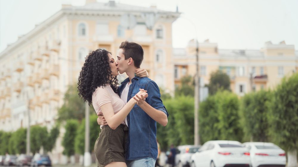 Teenagers kissing on a date outside