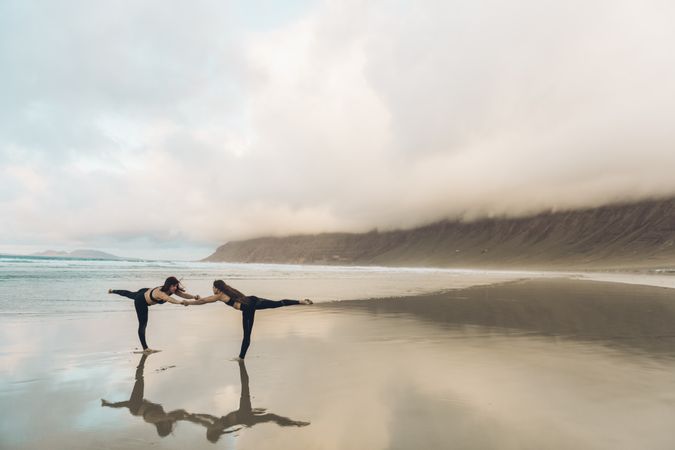 Women exercising near sea