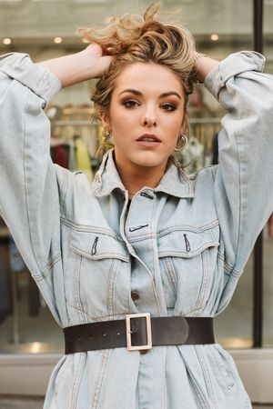 Trendy woman looking at shop window