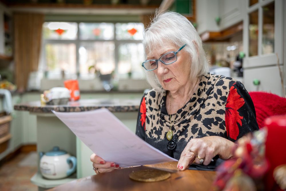 Woman reading papers at table