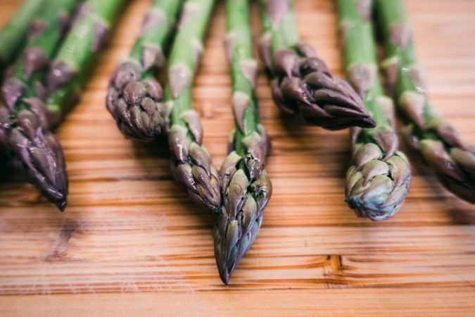 A bunch of green asparagus on wooden surface