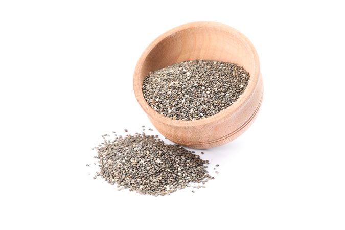 Chia seeds and wooden bowl isolated on plain background