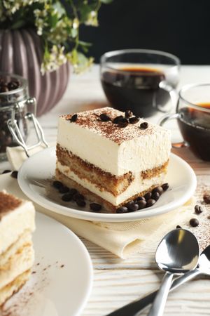 Composition with tasty tiramisu on blank wooden background. Delicious dessert