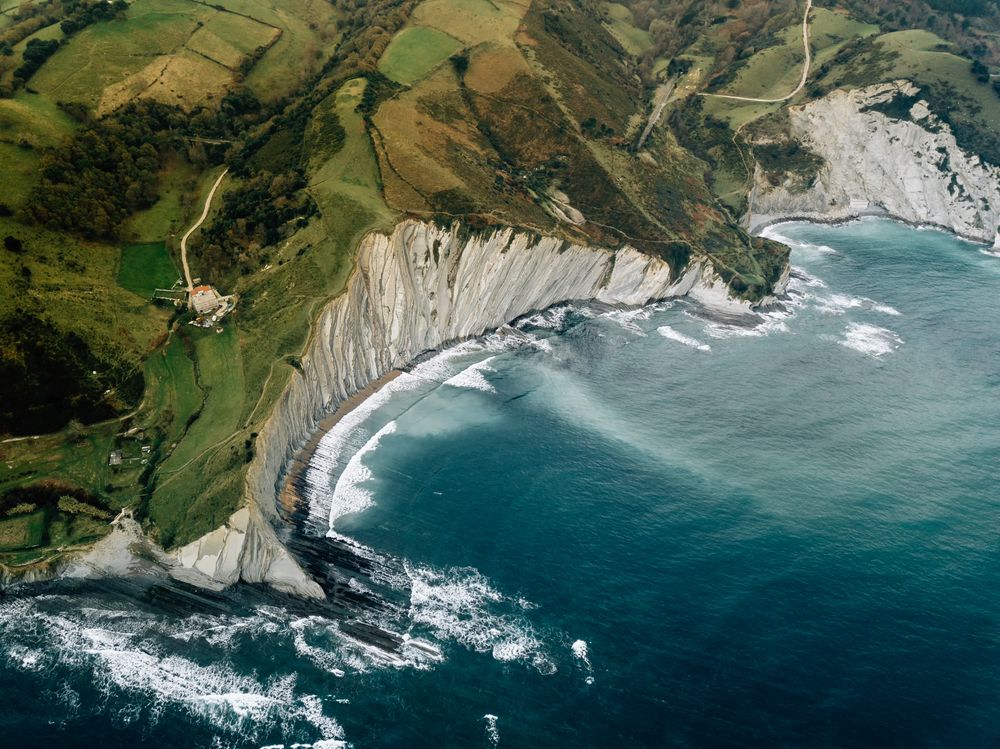 Sea waving near green hills
