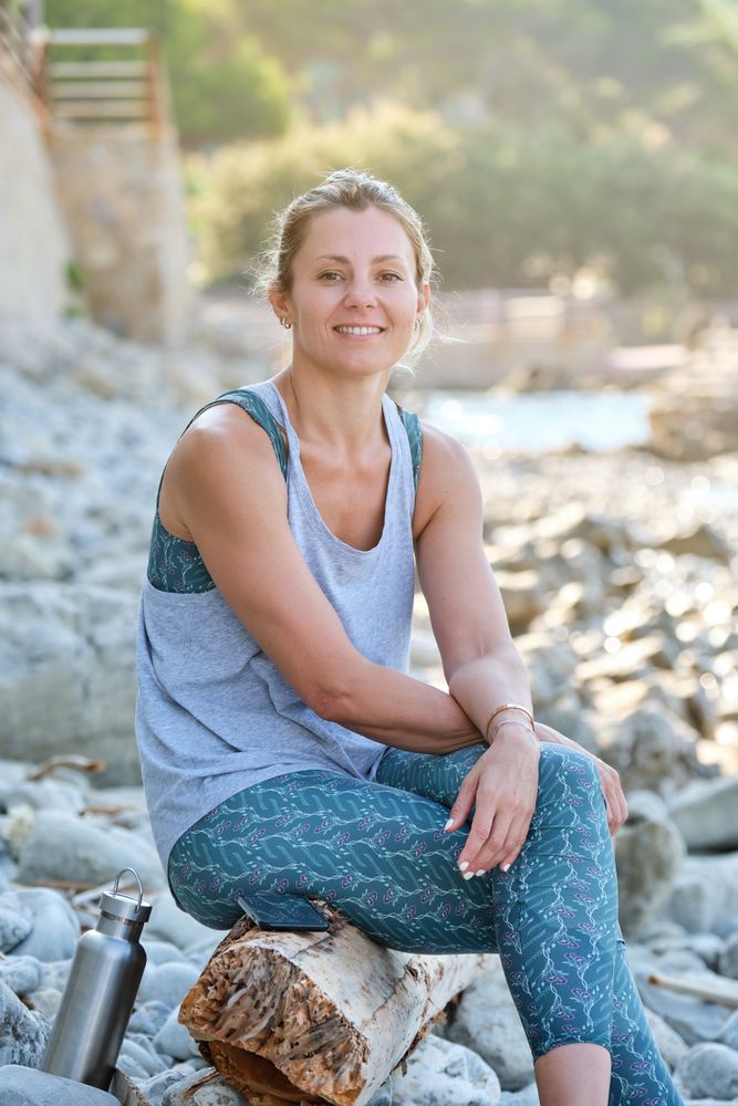 Smiling woman having rest after training in nature