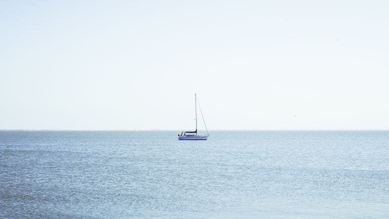 Boat between waves on water surface