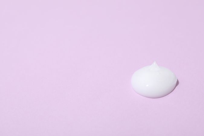Cream on violet background, space for text